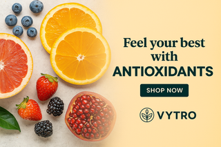 Assorted antioxidant-rich fruits and vegetables including berries, citrus, and leafy greens arranged on a wooden surface – natural sources of free-radical protection and immune support